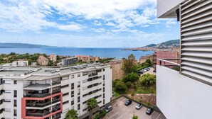 A high-rise building with multiple balconies overlooking a coastal cityscape. - Luminella - Avec vue sur la mer (Ajaccio)