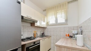 A modern kitchen with a gas stove, oven, and a coffee maker. - Apartment 2437/239180 (Istria - Pula), 1000m from the beach (Pula)