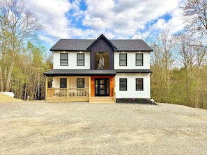A two-story house with a front porch, a garage, and a large driveway. - Luxury Retreat with Heated pool, sauna and jacuzzi (Covington township)