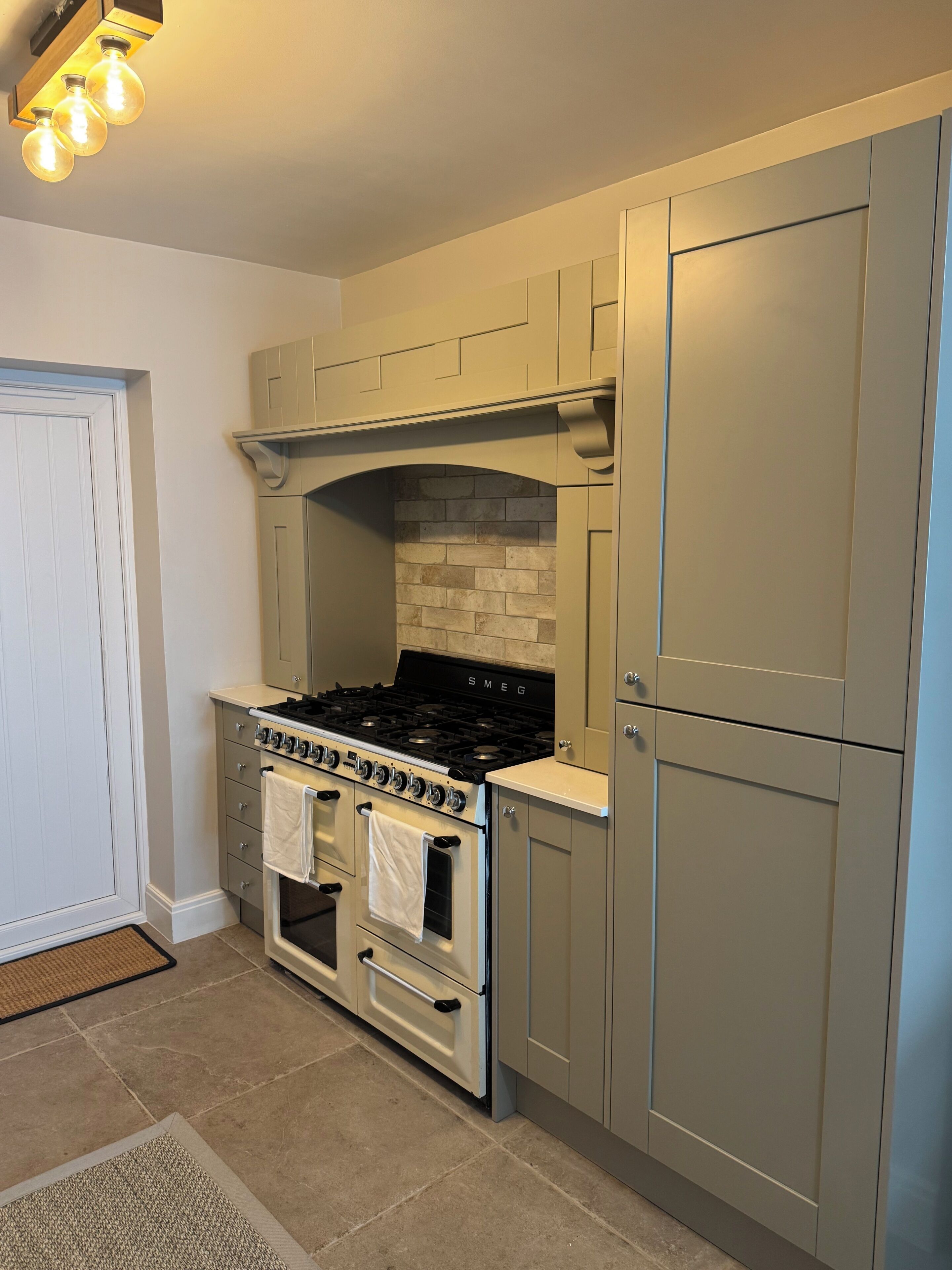 A compact kitchen with a built-in stove, oven, and a small countertop.