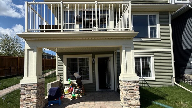 A two-story house with a balcony, a driveway, and a lawn. - 2 Bed Room, 1 Bath, Living, Kitchen, Office, Bright, Walkout Basement Suite (Calgary)