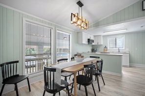 A dining area with a table, chairs, and a pendant light. - Serene Island Getaway, Golf Cart Included, Pet Friendly - 101 Sea Otter (Fripp Island)