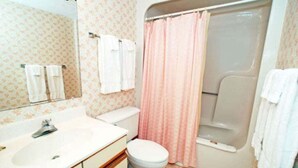 A bathroom with a sink, toilet, and shower.