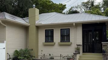 A single-story house with a front porch, a garage, and a driveway.