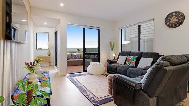 A modern living room with a sofa, a coffee table, and a TV. - Spacious 4BR Family Haven with Air-con & Parking (Auckland South)