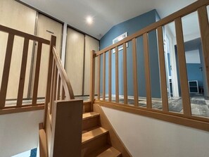 A staircase with wooden railings leading to an upper floor. - New house - 6 guests, near the town (Jard-sur-Mer)
