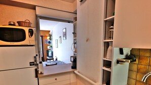 A compact kitchen with a microwave, refrigerator, and a sink. - Pleasant duplex with view - 6 guests (Le Grand-Bornand)