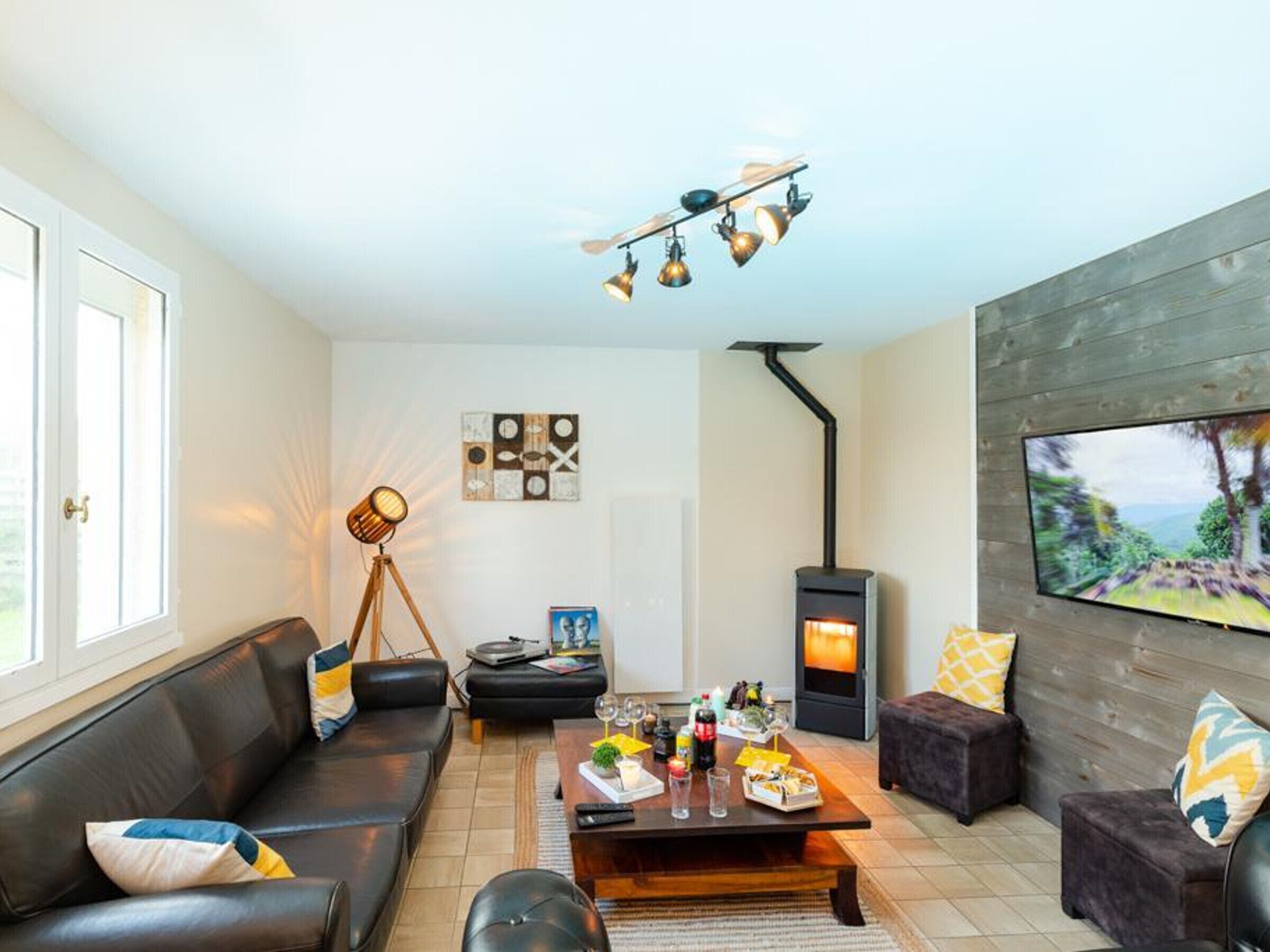 A living room with a sofa, coffee table, and a fireplace.