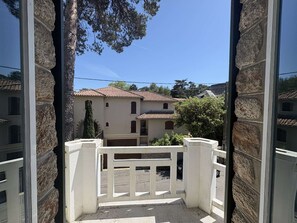 A building with a stone facade, a tiled roof, and a gated entrance.
