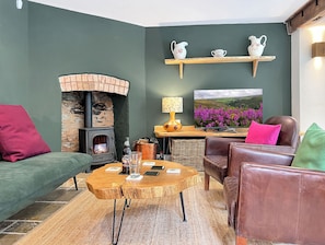 A cozy living room with a fireplace, a television, and comfortable seating. - Glen Cottage, Porlock (Porlock)