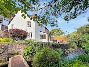 A house with a stone wall, a wooden fence, and a small stream. - Glen Cottage, Porlock (Porlock)