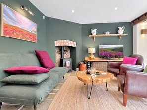 A cozy living room with a sofa, armchair, and a fireplace. - Glen Cottage, Porlock (Porlock)