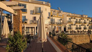 A building with balconies, outdoor seating, and a sign for 'Apartamentos Balcon del Mar'. - Spacious 3 bedroom house close to Nerja with pool and walled gardens. Sleeps 7 (Nerja)