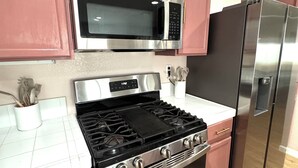 A kitchen with stainless steel appliances, including a microwave, stove, oven, and refrigerator.