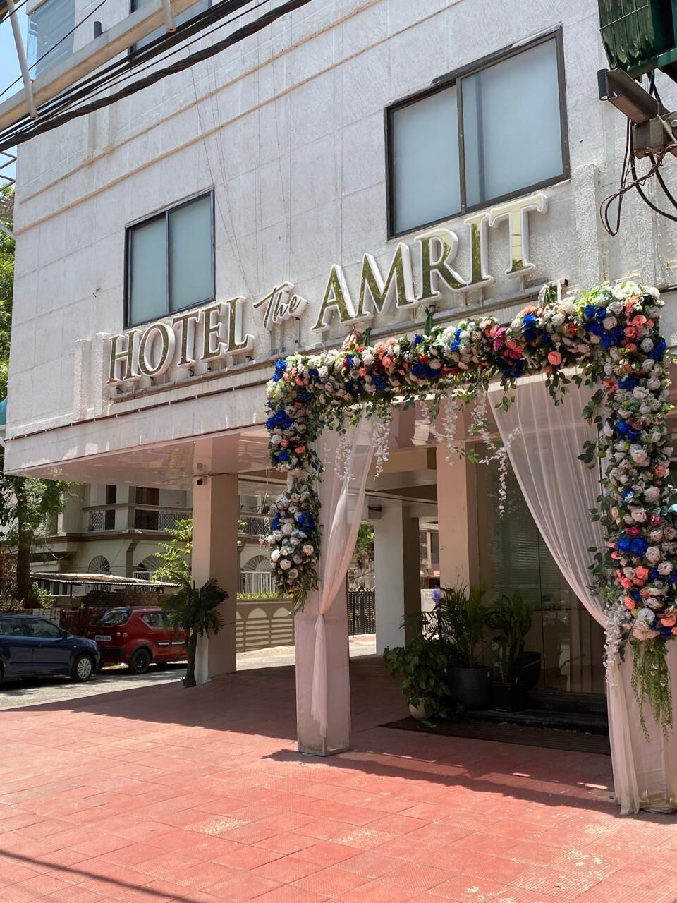 A hotel entrance with a sign that reads 'HOTEL AMRIT.'