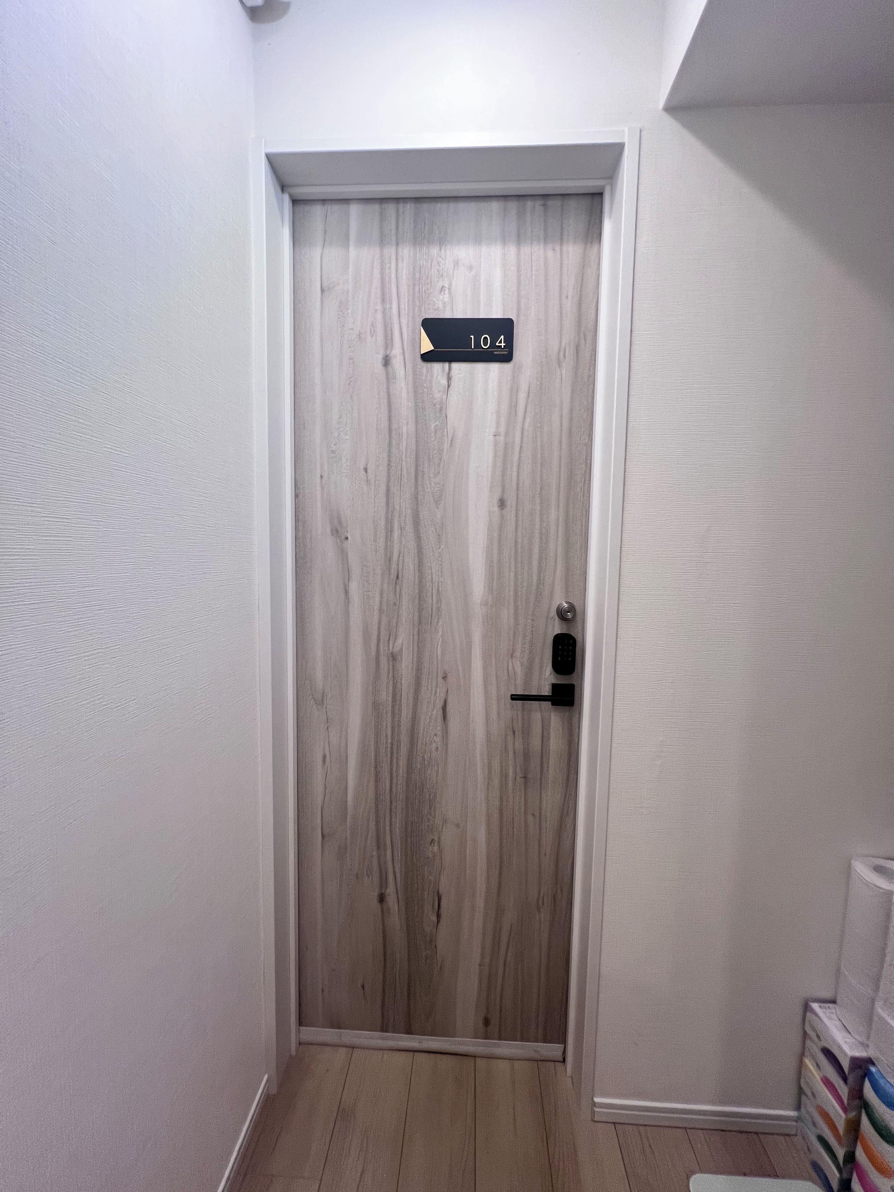 A door with a number plate, a keyhole, and a handle.