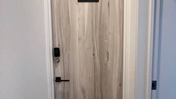 A door with a number plate, a door handle, and a keyhole.