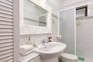 A bathroom with a sink, mirror, toilet, and shower. - Marisa Olive Grove - App Terra, Labin, Croatia (Labin)