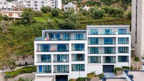 A modern multi-story building with balconies, a covered entrance, and a landscaped area with plants. - Velaris Partial Sea View Balcony 102, Vlore, Albania (Vlore)