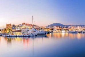 A coastal town with buildings, a marina, and a mountain in the background. - MI CAPRICHO BEACHFRONT: 210 with sea view (Mijas)