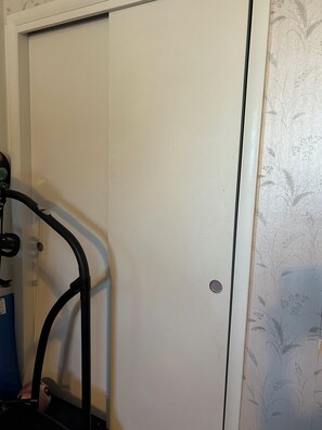 A white door with a small circular handle, a black metal frame, and a patterned wallpaper on the adjacent wall. - Short or Long Term 1 bedroom with bathroom in central Aurora (Aurora)