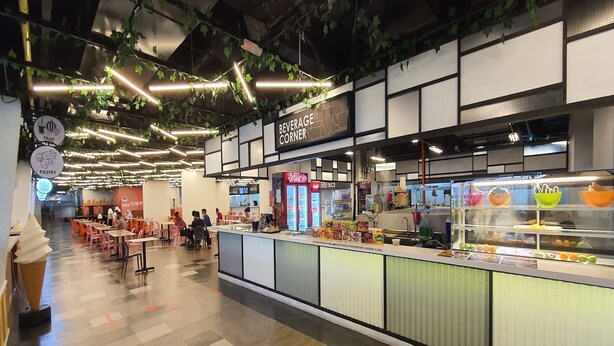 A cafe with a counter, tables, and a sign for the beverage corner. - 90309 Kozi Square (Kuching)