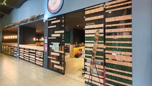 A restaurant with a modern design, featuring a prominent logo and a wooden facade. - 90309 Kozi Square (Kuching)