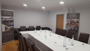 A conference room with a long table, chairs, and informational posters on the walls. - The Brander Lodge Hotel And Bistro (Taynuilt)
