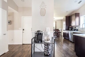 A kitchen with a coffee machine, a coffee pot, and a wine rack. - Spacious Single Level Home with 2 King Beds Sleeps 8 (Salida)