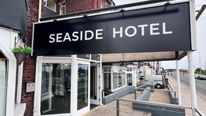 A sign for Seaside Hotel with a wooden deck and outdoor seating. - Chatsworth Hotel (Skegness)