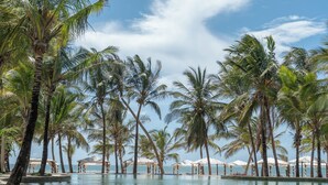 A pool area with palm trees and umbrellas. - Billionaire Resort And Retreat (Malindi)