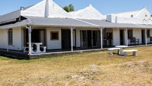 A white building with a covered porch and a satellite dish. - Vyge Valley Estate (Cape Town)