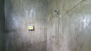 A bathroom with a shower, a towel rack, and a soap dispenser. - Moonshine Resort Chumphon (Chumphon)