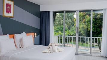 A hotel room with a large bed, a view of the outdoors, and a balcony.