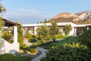 A resort with multiple white buildings, a pathway, and greenery.