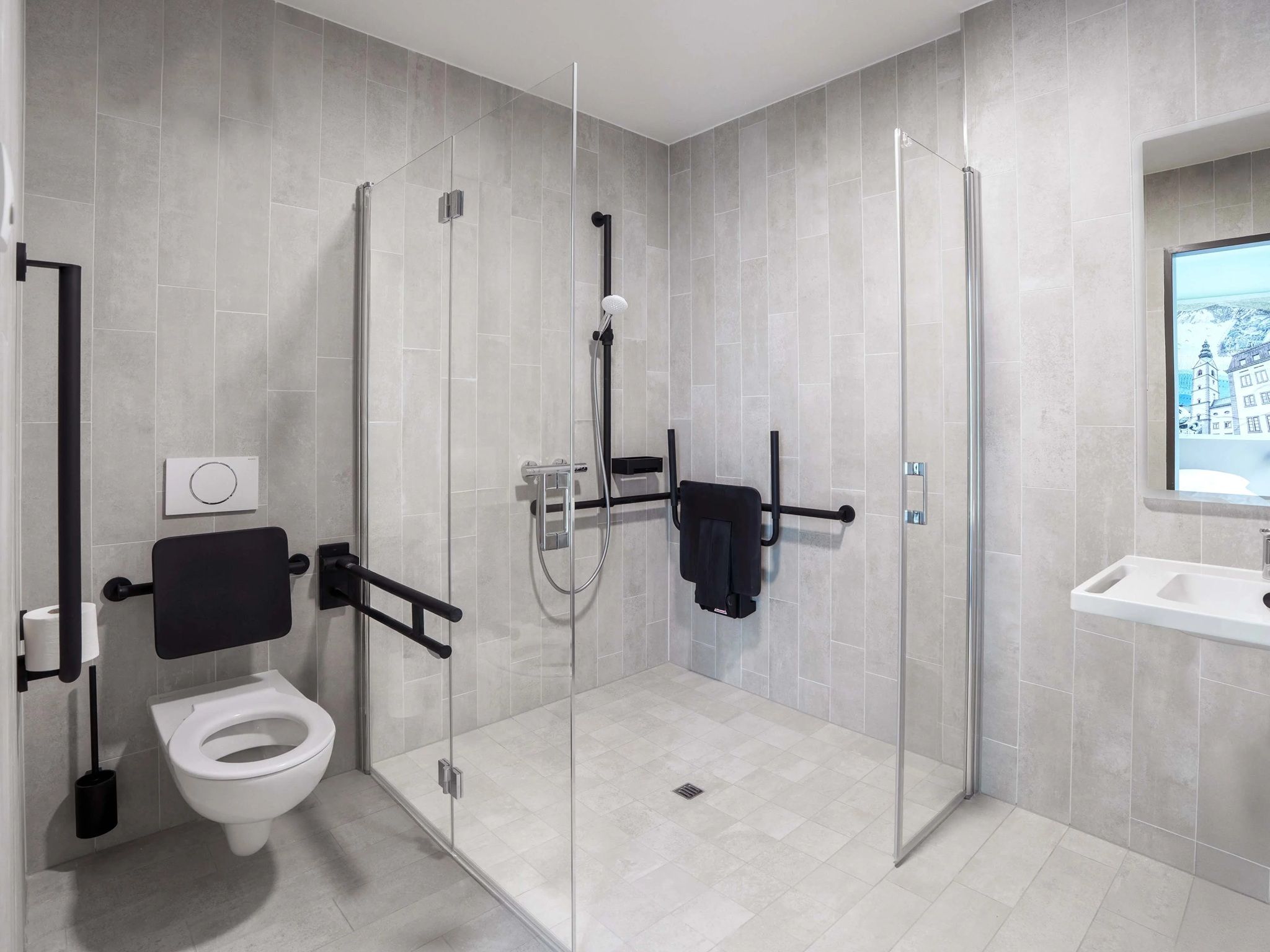 A modern bathroom with a glass-enclosed shower, a toilet, and a sink.