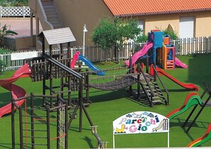 A playground with slides and climbing structures.