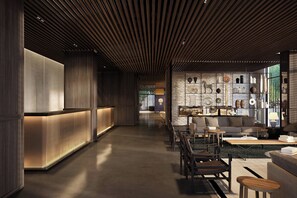 A modern interior with a reception desk, seating area, and display of decorative items. - Roomers Parkview, A Luxury Collection Hotel, Frankfurt (Frankfurt)