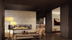 A modern interior with a fireplace, seating, and a wooden ceiling. - Roomers Parkview, A Luxury Collection Hotel, Frankfurt (Frankfurt)
