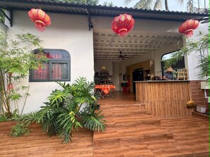 A building with a wooden floor, a window, and red lanterns.