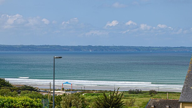 A coastal view with a beach, ocean, and distant hills. - R Sidence Les Terrasses de Pentrez M24v (Saint-Nic)