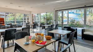 A modern cafe with outdoor seating, large windows, and a view of the surrounding area. - Le Domaine des Grands Lacs M48s (Parentis-en-Born)