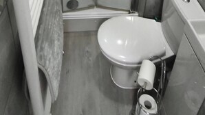 A compact bathroom with a shower, toilet, and a towel rack. - Room-cozy Double Room Near City Centre & (Chelmsford)