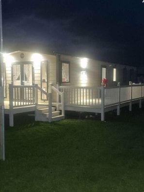 A row of cabins with white railings and a porch, connected by a walkway. - Marine Holiday Park - Holiday Accommodation 16604 (Rhyl)