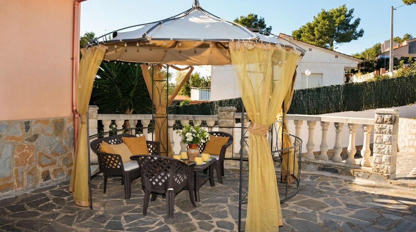 An outdoor patio with a table, chairs, and a canopy.