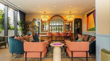 A modern interior with seating, a bar area, and large windows.