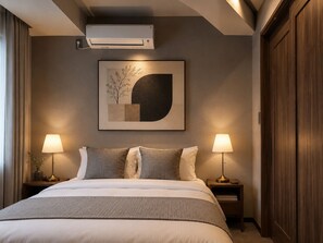A hotel room with a bed, two bedside lamps, an air conditioner, a framed abstract artwork, and a wooden wardrobe. - KITAYAMA HOTEL ASAKUSA (Taito-ku)
