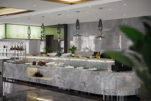 A modern kitchen with a marble countertop, hanging pendant lights, and a cityscape view. - Shanghai Kacunm Hotels (Shanghai)
