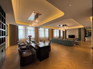 A modern living room with a dining area, large windows, and a flat-screen TV. - Shanghai Kacunm Hotels (Shanghai)
