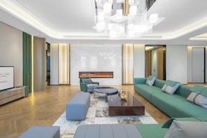 A modern living room with a sofa, a coffee table, and a TV. - Shanghai Kacunm Hotels (Shanghai)
